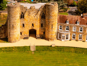 A shot of the castle, manor house and gardens from the air