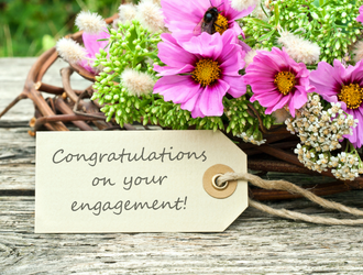 A bouquet of flowers with a sign reading congratulations on your wedding
