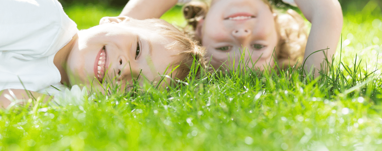 Smiling children in the grass