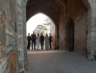A wedding group at the castle entrance looking toward the bailey lawn