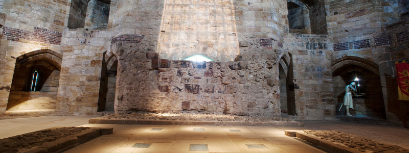 A long shot of the great hall with an archer in the corner of the room