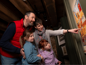 Family looking at a information board